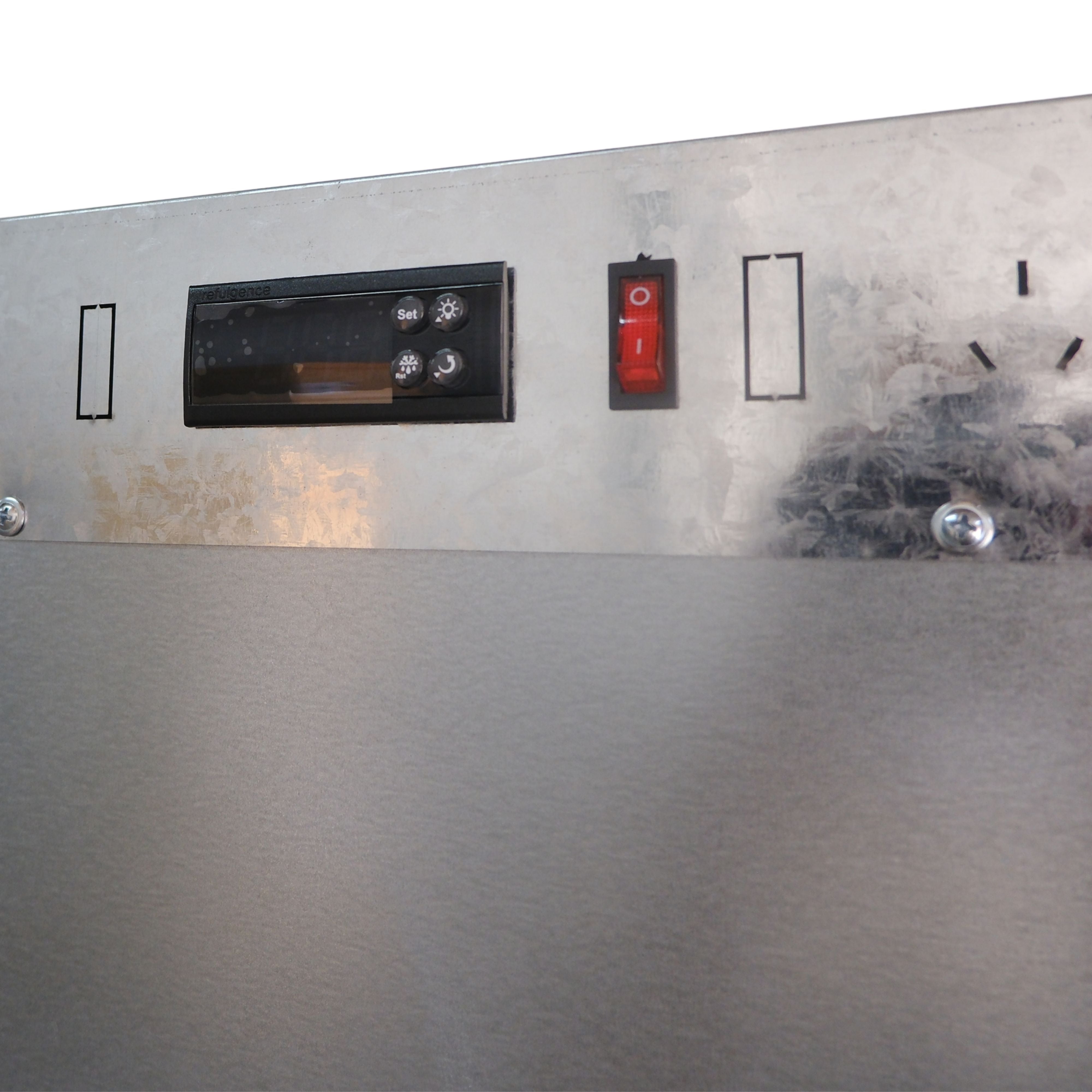 Control panel with buttons and display on a metallic surface
