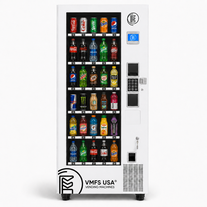 A white VMFS USA Drinks and soda vending machine filled with assorted bottled and canned beverages. The machine has a glass front door with multiple beverage rows, a coin and card reader, keypad, and VMFS USA branding near the bottom.
