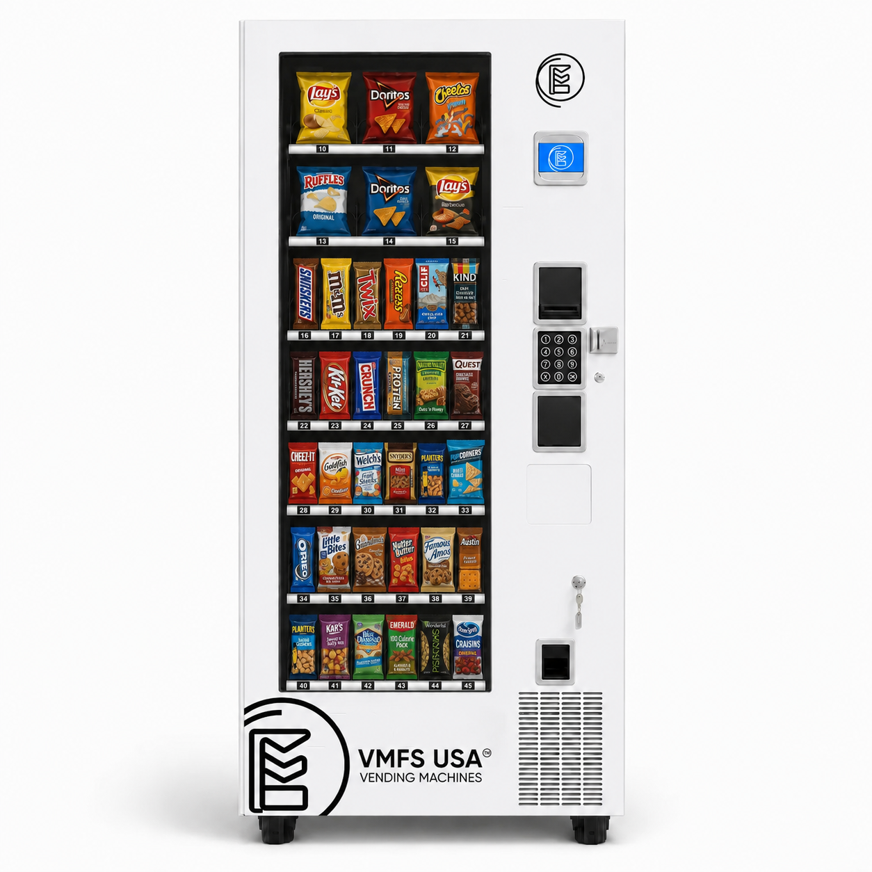 A white commercial snack vending machine with multiple shelves of assorted packaged chips, candy, and snacks, shown on a clean white background. The machine features a digital display, keypad, coin slot, and a visible VMFS USA branding logo near the bottom.